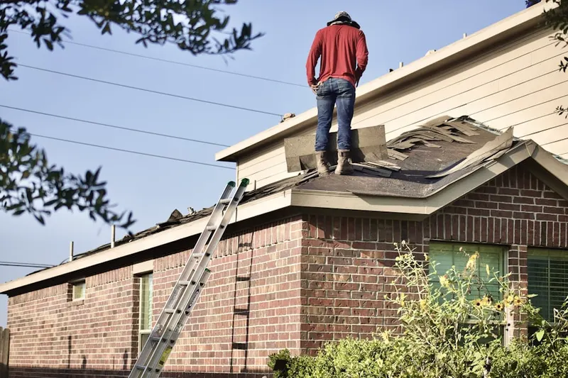 Professional roofer working on a residential roof in Hurley